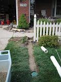 2006-07-06.gutter_downspout.adding.drain.under.sidewalk.pop_up_outlet.3.livonia.mi.us.jpg